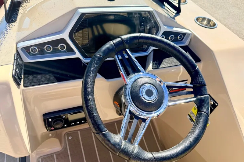 Slide: The Image of Steering wheel and dashboard of 2021 Manitou 23 Oasis boat. - 46