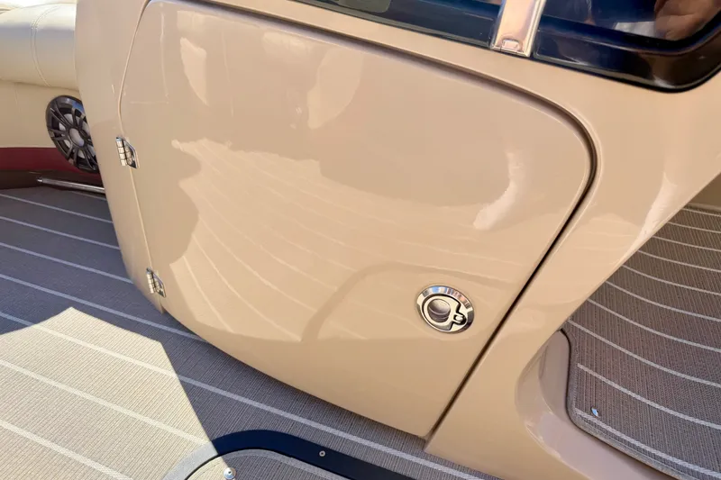 Slide: The Image of 2021 Manitou 23 Oasis boat interior with beige panel and speaker detail. - 57