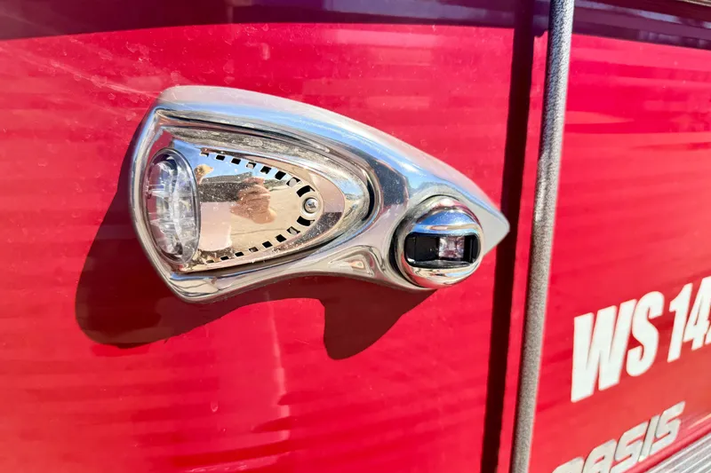 Slide: The Image of Close-up of a 2021 Manitou 23 Oasis boat light on a red surface. - 17