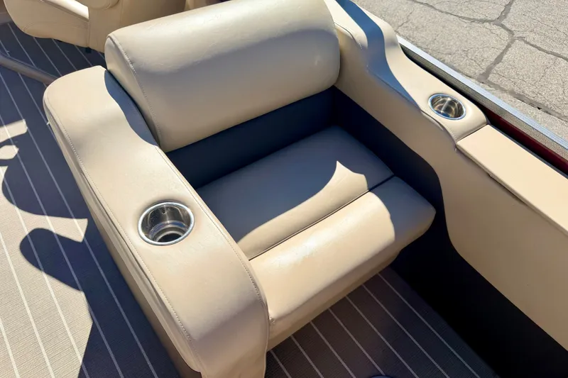 Slide: The Image of Beige seating with cup holders on a 2021 Manitou 23 Oasis boat. - 33