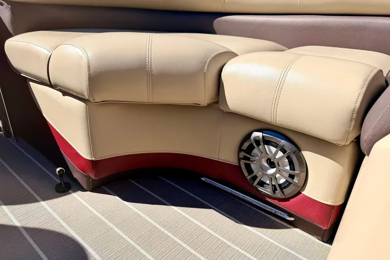 Slide: The Image of Beige leather seating with speaker detail on 2021 Manitou 23 Oasis boat. - 86