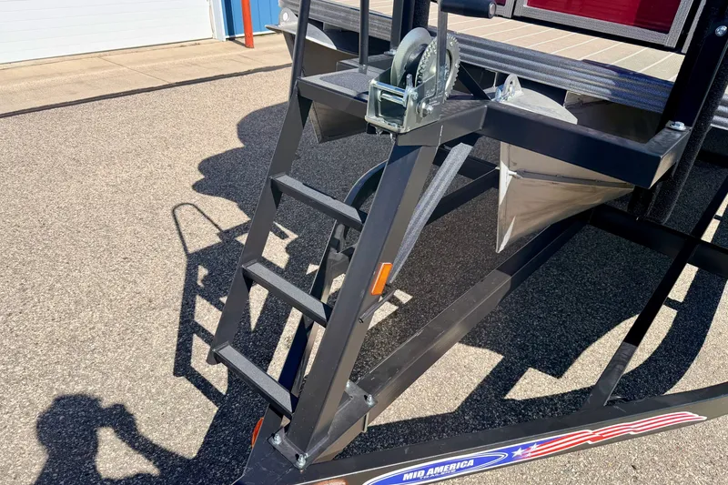 Slide: The Image of Trailer ladder and winch on a 2021 Manitou 23 Oasis boat trailer. - 114