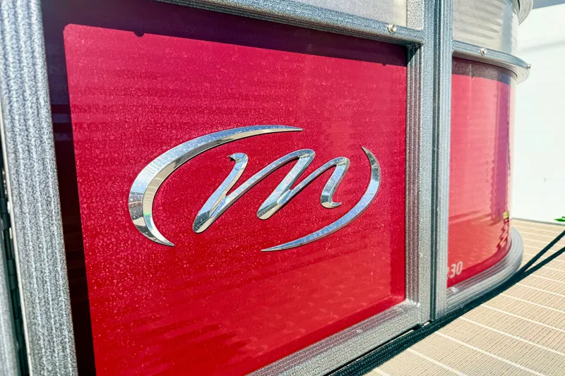 Slide: The Image of Red Manitou 23 Oasis 2021 boat with chrome logo detail. - 21