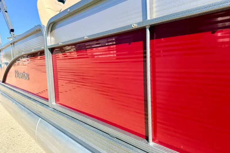 Slide: The Image of Red and silver exterior of a 2021 Manitou 23 Oasis pontoon boat. - 19