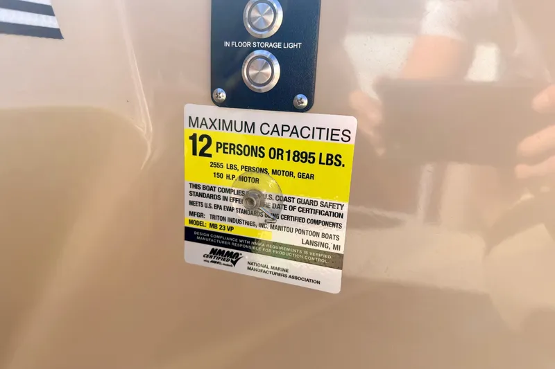 Slide: The Image of Maximum capacity label on 2021 Manitou 23 Oasis boat, indicating 12 persons or 1895 lbs. - 51