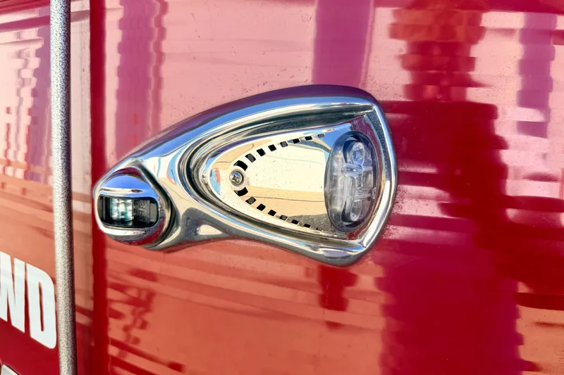 Slide: The Image of Close-up of a 2021 Manitou 23 Oasis boat light on a red surface. - 15