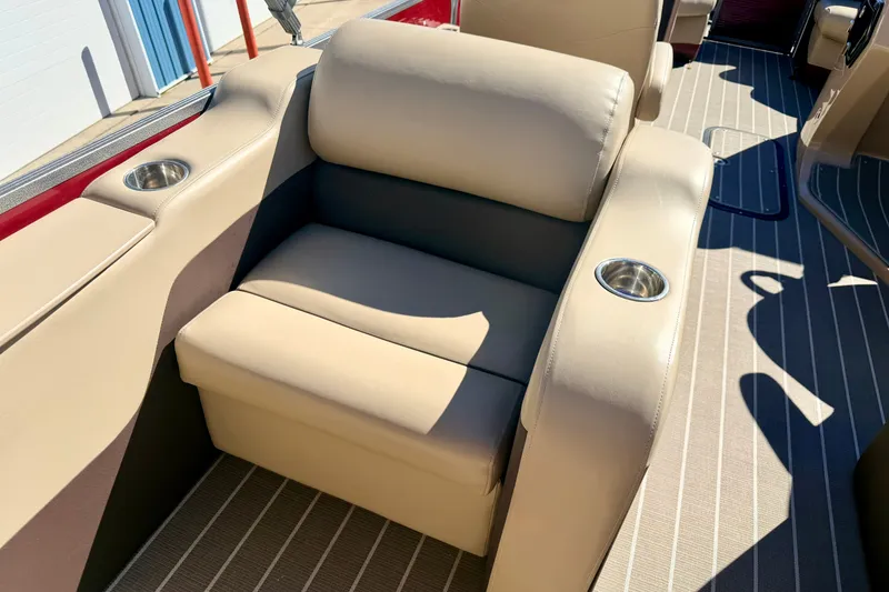Slide: The Image of Luxurious seating on 2021 Manitou 23 Oasis boat with cup holders and beige upholstery. - 40