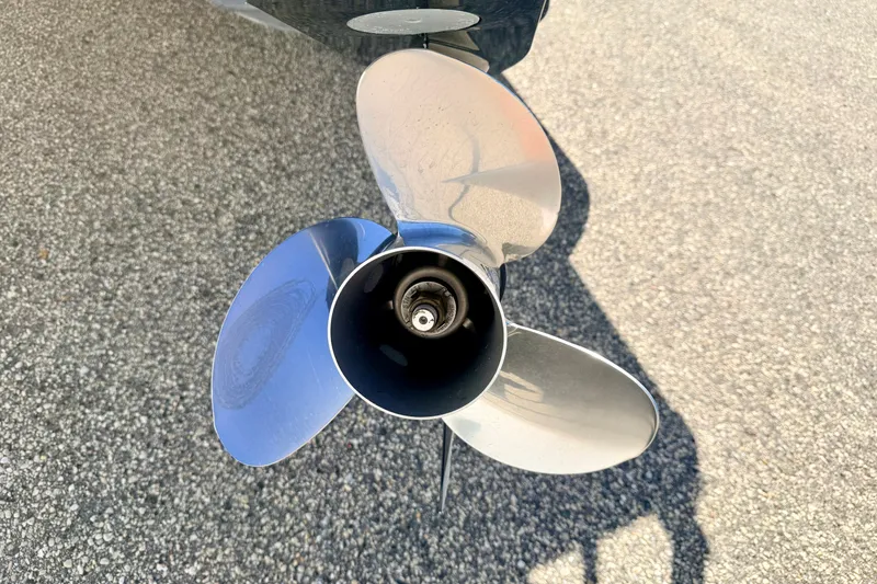 Slide: The Image of Propeller of 2021 Manitou 23 Oasis boat on asphalt surface. - 26
