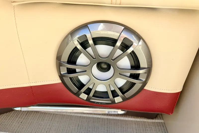 Slide: The Image of Speaker on 2021 Manitou 23 Oasis boat, beige and red interior detail. - 81