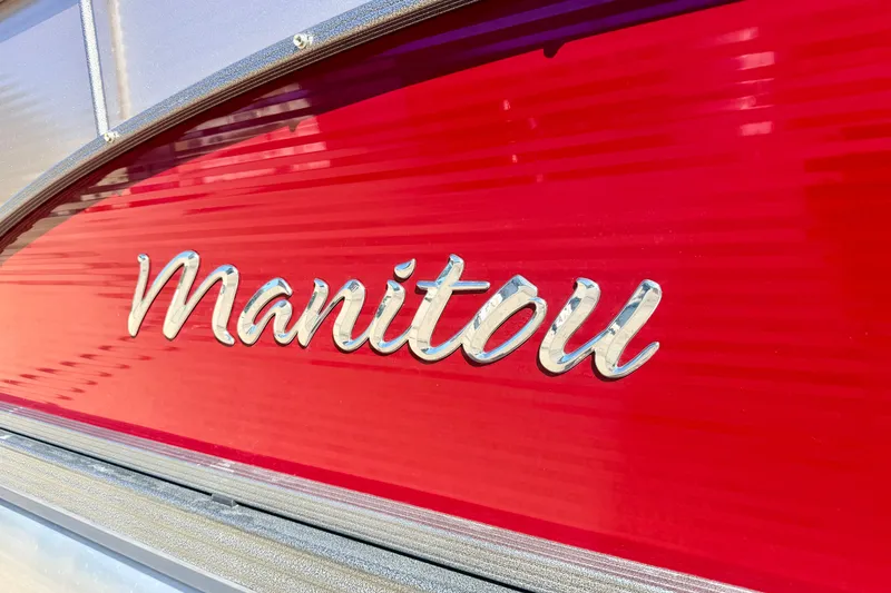 Slide: The Image of Close-up of 2021 Manitou 23 Oasis logo on vibrant red background. - 18