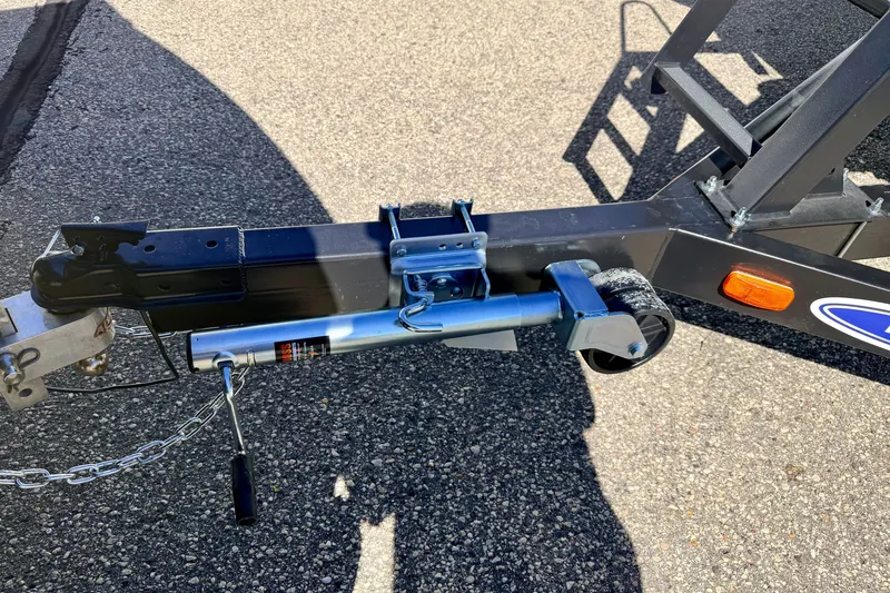 Slide: The Image of Trailer hitch and jack of a 2021 Manitou 23 Oasis on asphalt surface. - 91