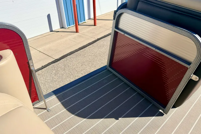 Slide: The Image of Interior view of 2021 Manitou 23 Oasis boat with red and beige seating. - 63