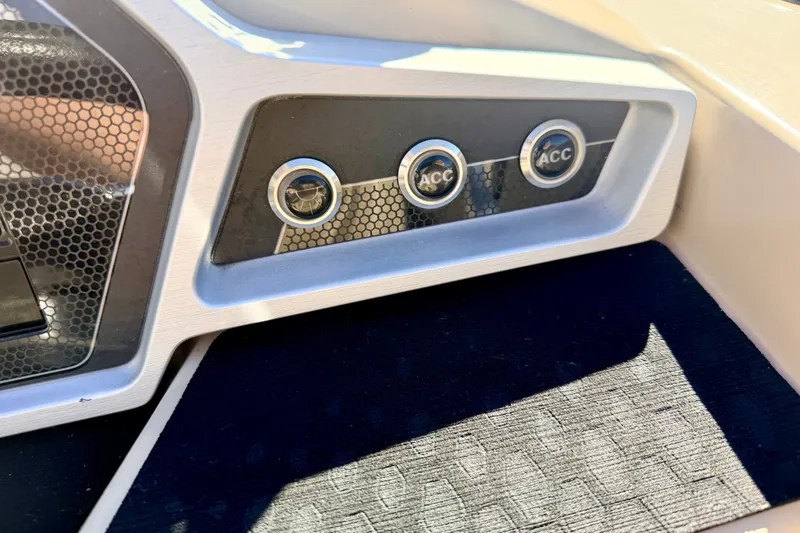 Slide: The Image of Dashboard of 2021 Manitou 23 Oasis boat with accessory switches. - 49