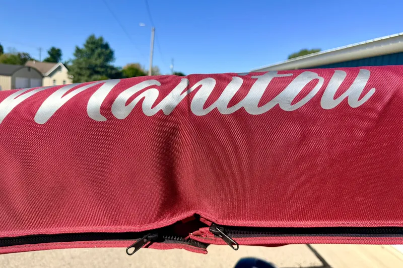 Slide: The Image of Red Manitou cover with zipper, showcasing the 2021 Manitou 23 Oasis model. - 84