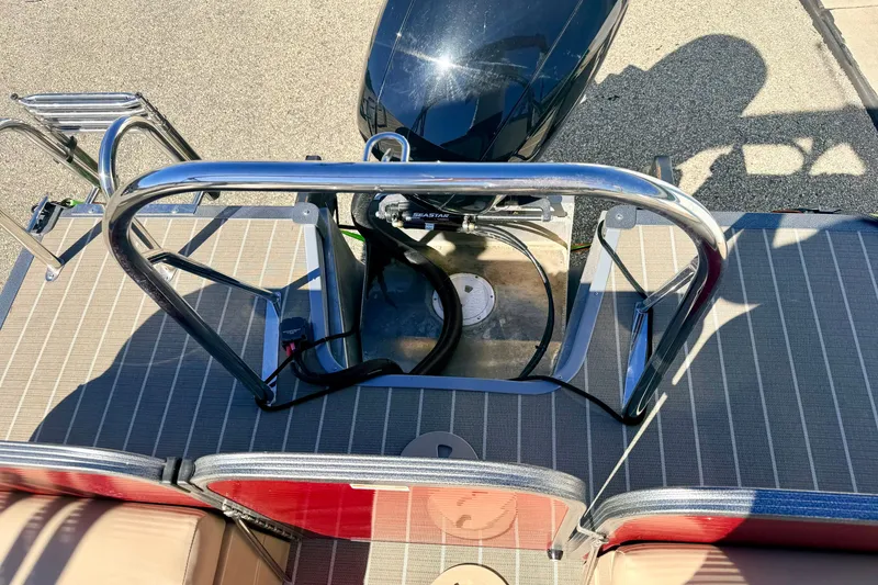Slide: The Image of 2021 Manitou 23 Oasis boat deck with motor and stainless steel railing. - 30
