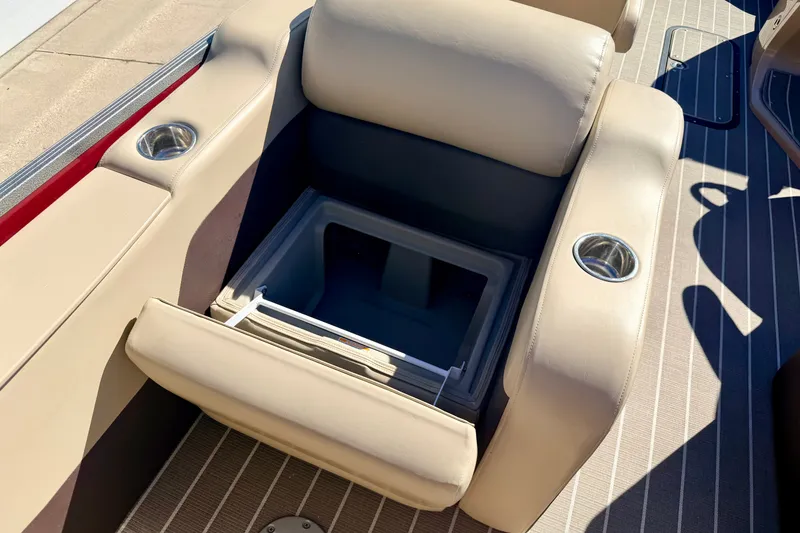 Slide: The Image of 2021 Manitou 23 Oasis boat seat with built-in storage and cup holders. - 41