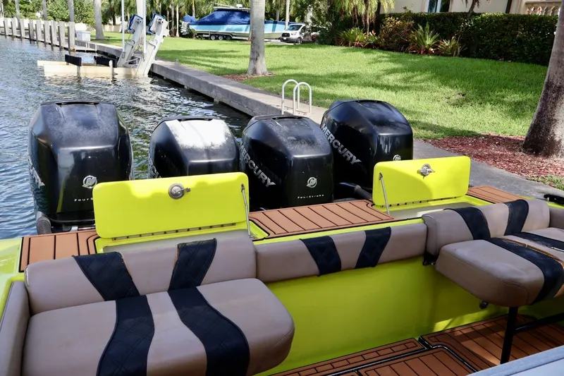 Slide: The Image of 2016 Midnight Express 43 Open boat with four Mercury outboard engines, docked by a canal. - 19