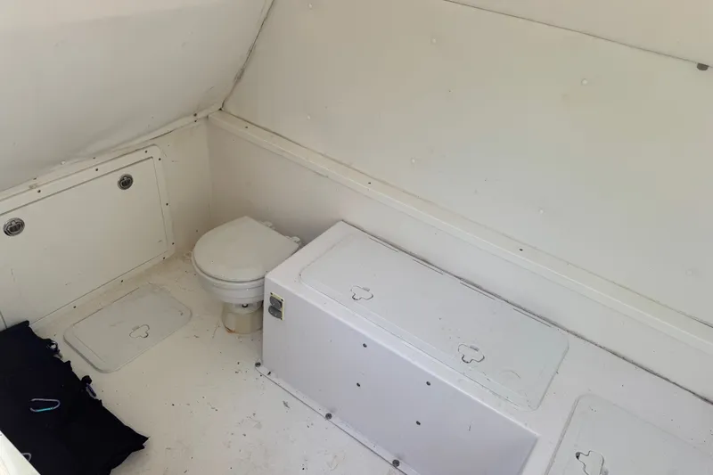 Slide: The Image of 2016 Midnight Express 43 Open boat interior with toilet and storage compartments. - 22