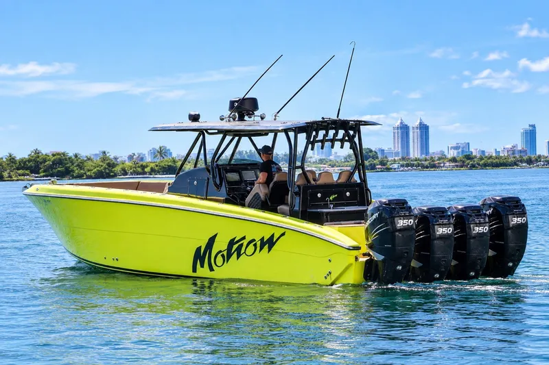 The Image of 2016 Midnight Express 43 Open boat with four Mercury engines on blue water. - 1