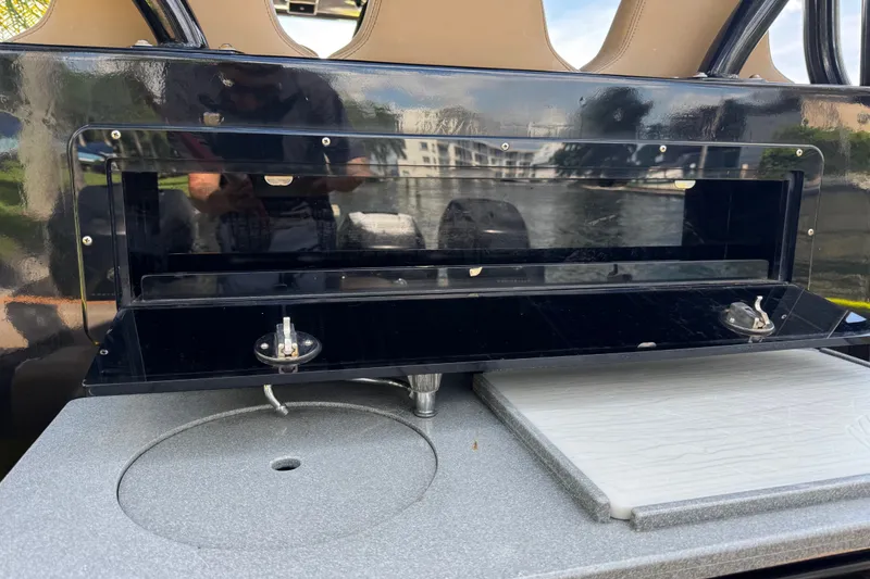 Slide: The Image of Open storage compartment on 2016 Midnight Express 43 Open boat, featuring sleek black design. - 17
