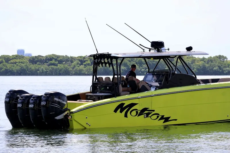 Slide: The Image of 2016 Midnight Express 43 Open boat with four Mercury engines on a calm lake. - 6