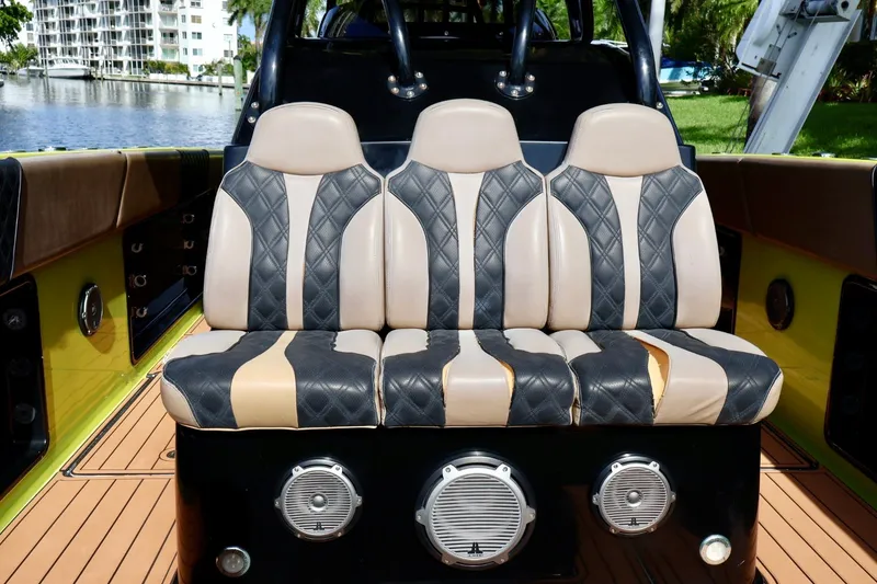 Slide: The Image of Luxurious seating on a 2016 Midnight Express 43 Open boat, featuring quilted upholstery. - 9