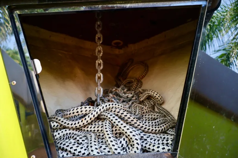Slide: The Image of Storage compartment with coiled rope and chain on a 2016 Midnight Express 43 Open boat. - 13