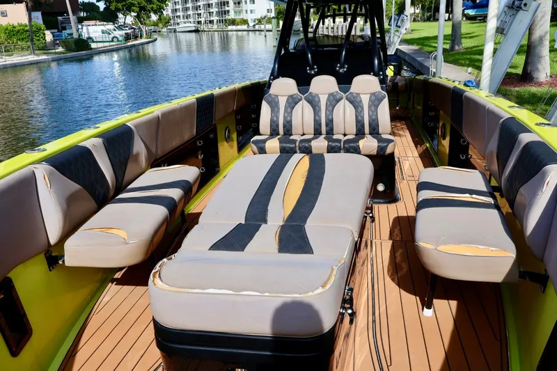 Slide: The Image of 2016 Midnight Express 43 Open boat interior with worn seating and wooden deck. - 8