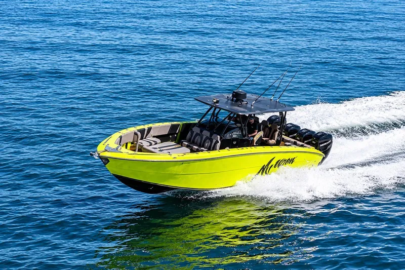 Slide: The Image of Bright yellow 2016 Midnight Express 43 Open boat cruising on clear blue water. - 5