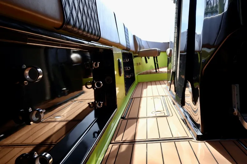 Slide: The Image of Interior view of a 2016 Midnight Express 43 Open boat, featuring sleek design and wood flooring. - 11