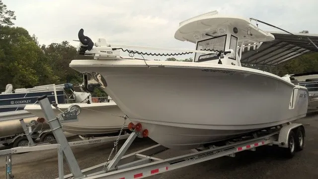 Slide: The Image of A 2024 Sea Pro 262 Center Console boat on a trailer, ready for use. - 1