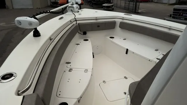 Slide: The Image of The image shows the bow area of a 2024 Sea Pro 262 Center Console boat with seating and storage. - 7