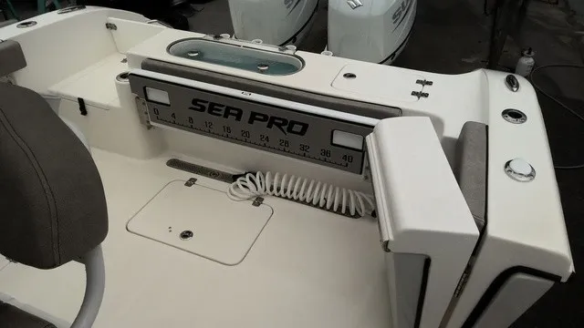 Slide: The Image of The image shows the cockpit of a 2024 Sea Pro 262 Center Console boat with a measuring scale. - 6