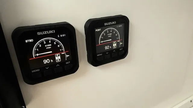 Slide: The Image of Two Suzuki gauges display engine data on a boat console. - 10