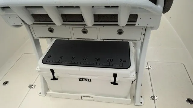 Slide: The Image of The image shows a Yeti cooler beneath a bench with drawers on a boat. - 15