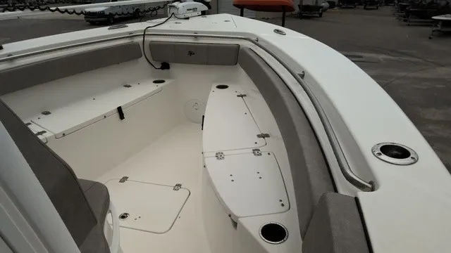 Slide: The Image of The image shows the bow area of a 2024 Sea Pro 262 Center Console boat with seating and storage. - 8