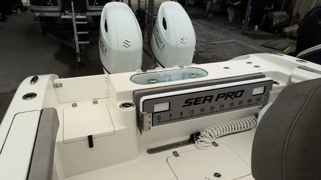 Slide: The Image of The image shows the stern of a Sea Pro 262 Center Console boat with two outboard engines. - 13