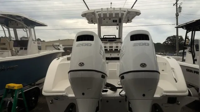 Slide: The Image of The image shows a 2024 Sea Pro 262 Center Console boat with twin outboard engines. - 2
