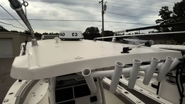 Slide: The Image of The image shows the roof of a Sea Pro 262 Center Console boat with fishing rod holders. - 5