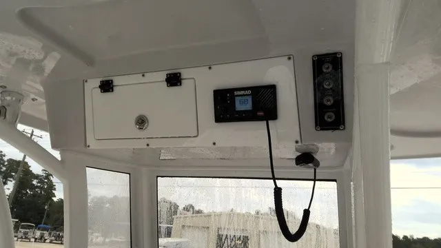 Slide: The Image of The image shows the helm of a 2024 Sea Pro 262 Center Console boat with electronics. - 12