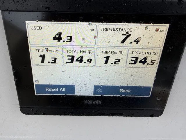 Slide: The Image of A Yamaha screen displays fuel usage and trip data, with water droplets on the display. - 18