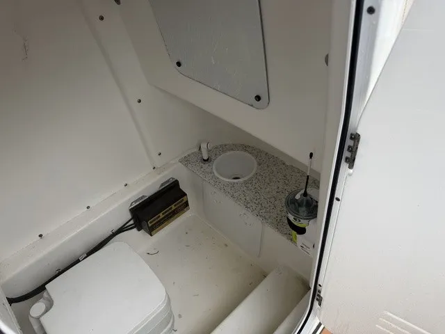 Slide: The Image of Interior view of a boat with a small toilet and sink. - 16