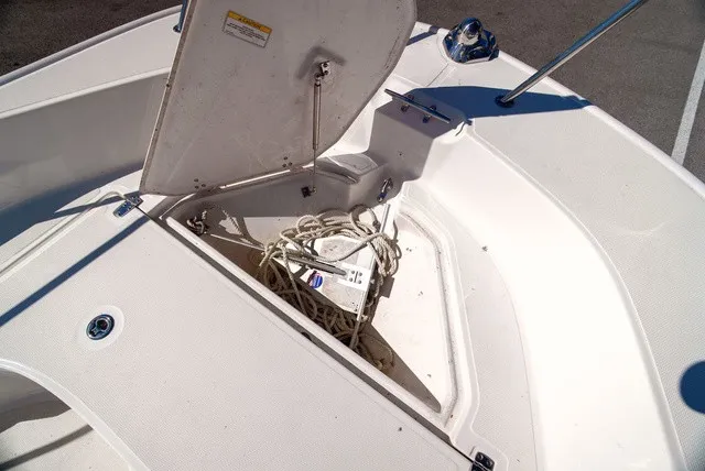 Slide: The Image of The image shows the bow of a Boston Whaler 170 Montauk with an open storage compartment. - 22