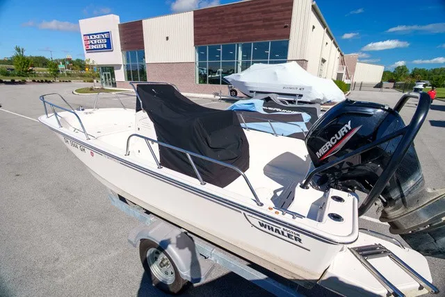 Slide: The Image of A 2022 Boston Whaler 170 Montauk on a trailer outside a building. - 1