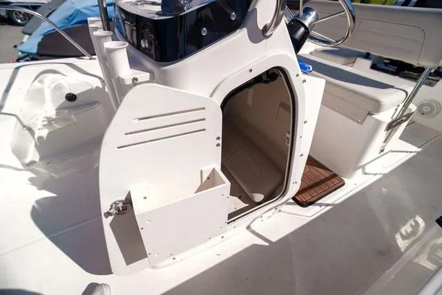 Slide: The Image of The image shows the interior of a 2022 Boston Whaler 170 Montauk with an open storage compartment. - 18