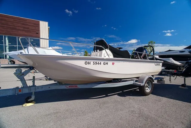 The Image of A 2022 Boston Whaler 170 Montauk on a trailer in front of a modern building. - 0