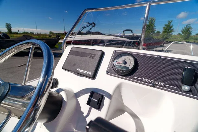 Slide: The Image of The image shows the helm of a 2022 Boston Whaler 170 Montauk with a Raymarine display. - 13