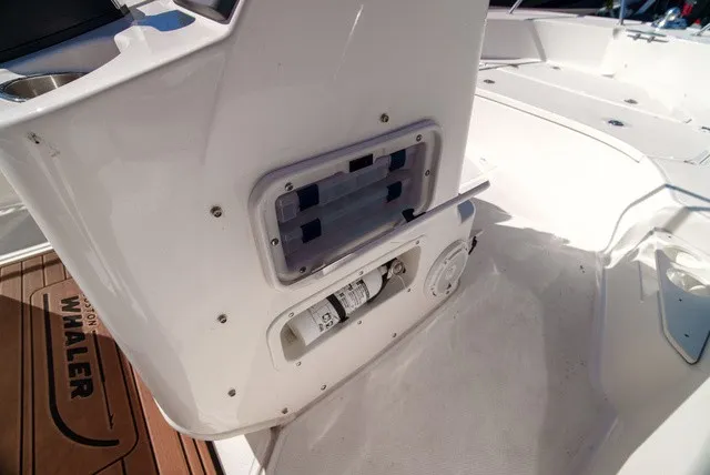 Slide: The Image of The image shows the cockpit of a 2022 Boston Whaler 170 Montauk with storage and helm console. - 15