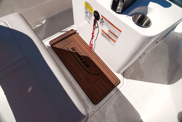 Slide: The Image of Close-up of the cockpit area of a Boston Whaler 170 Montauk with a non-slip floor mat. - 12