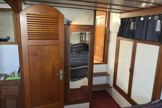 Slide: The Image of Interior of 1983 Roughwater 41 boat with wooden cabinetry and mirror. - 22
